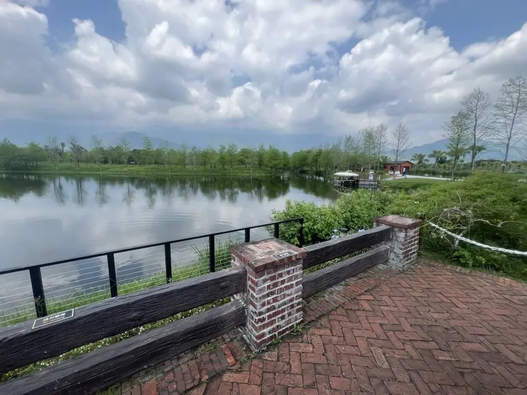 Promisedland Resort wooden railing lagoon and distant mountains — Taiwan Insider